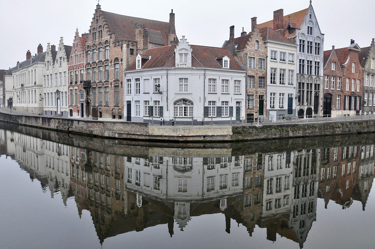 Big house reflected on water below