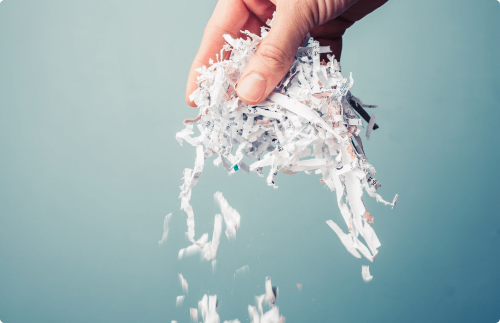 Hand lifting shredded paper