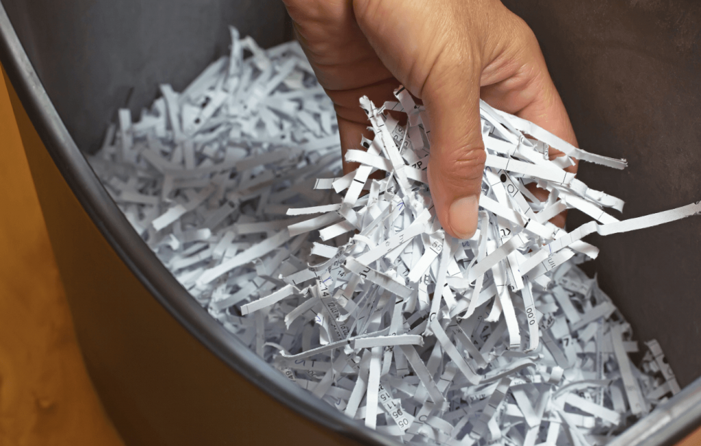 Hand holding shredded paper